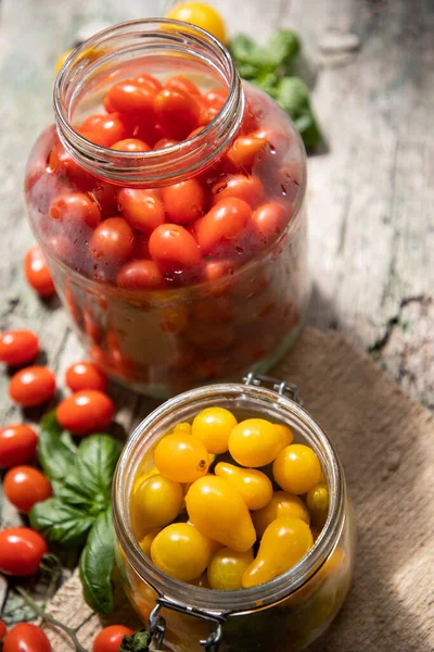 red and yellow cherry tomatoes in a jar for winter
