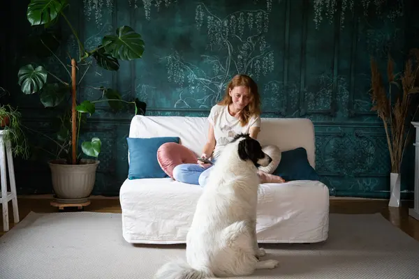 woman with white dog in living room