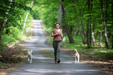 Ormanda köpekleriyle mutlu bir kadın.