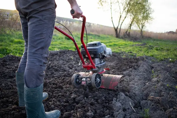 Organic Farming Man Ploughs Ground Sunset Tiller Preparing Soil Sowing Royalty Free Stock Photos