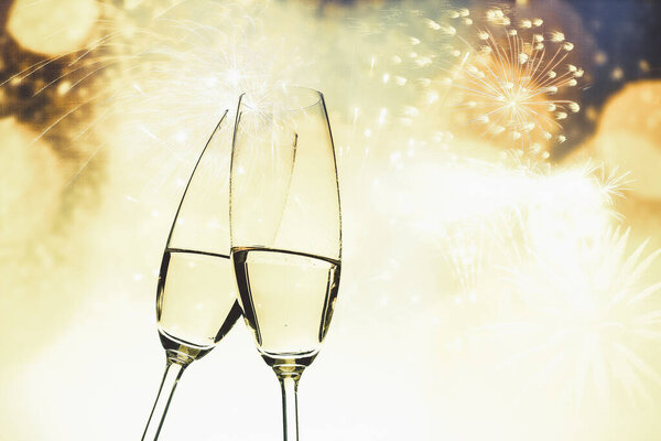 toasting with champagne glasses on sparkling holiday background - Fireworks at New Year and copy space
