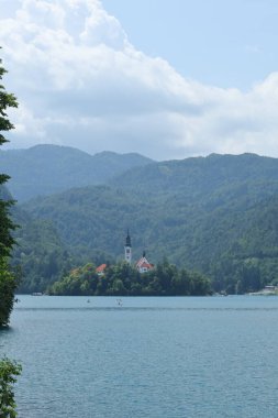 Güzel bir kilise, yeşil tepelerle çevrili sakin mavi bir göldeki bir adada tek başına duruyor..