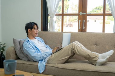 Happy cheerful businessman in home office.