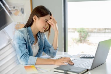 Architect design works drawing sketches, plans, blueprints and building architectural construction models in an architect studio.