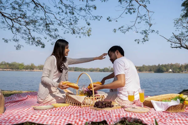 stock image Couple having a picnic in a beautiful and natural park