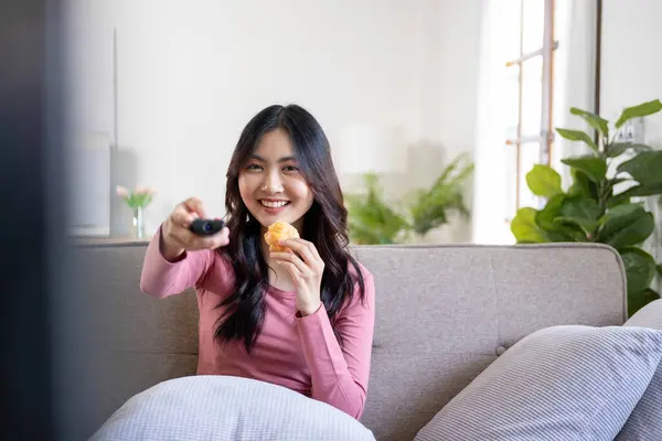 stock image Beautiful asian businesswoman, entrepreneur, or freelance in casual clothes sitting at desk with paperworks and laptop casually working online in living room at home. At home, business concept.  