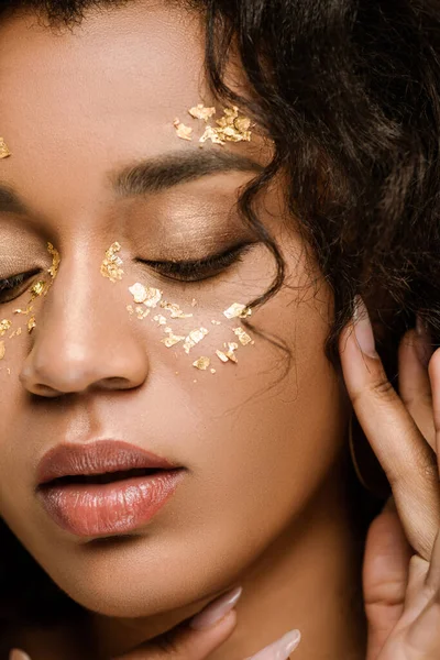 stock image close up of brunette african american woman with golden body paint on cheeks 