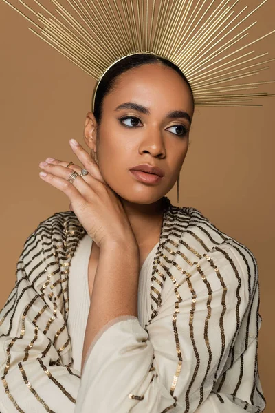 stock image african american young woman in shiny shawl and golden crown posing isolated on beige 