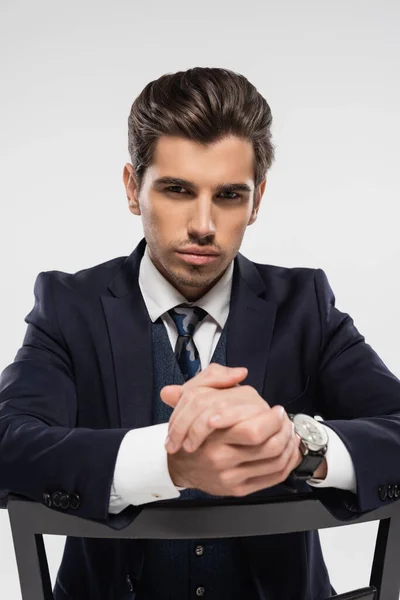 Serious Businessman Clenched Hands Sitting Chair Isolated Grey — Stock Photo, Image