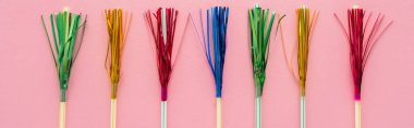 Top view of drinking straws with colorful tinsel on pink background, banner  clipart