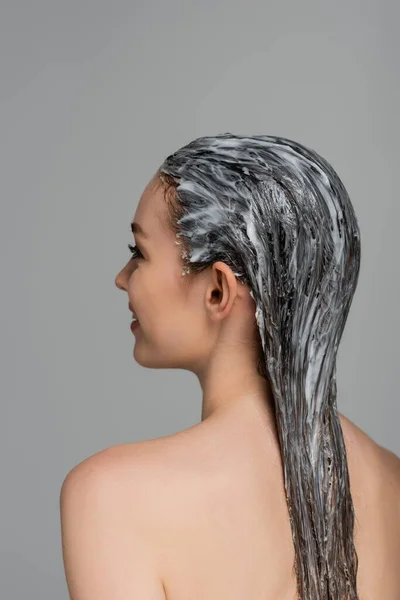 stock image cheerful young woman with bare shoulders and mask on wet hair isolated on grey 