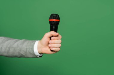 Yeşilde izole edilmiş bir şekilde mikrofonu elinde tutan gazetecinin görüntüsü 