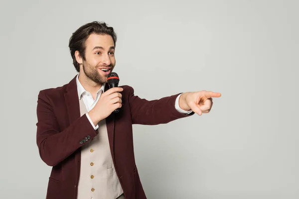Excited Showman Formal Wear Talking Microphone Pointing Away Finger Isolated — Stock Photo, Image