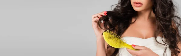 stock image partial view of woman holding hair brush with damaged and lost hair isolated on grey, banner