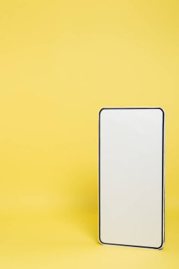 vertical view of white template of mobile phone on yellow background