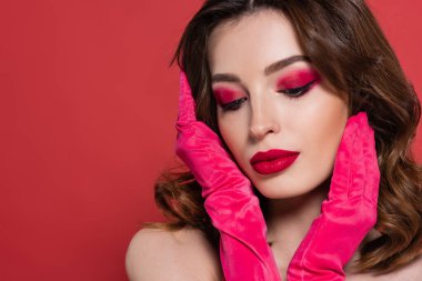 portrait of young woman in bright magenta color gloves posing isolated on pink  clipart