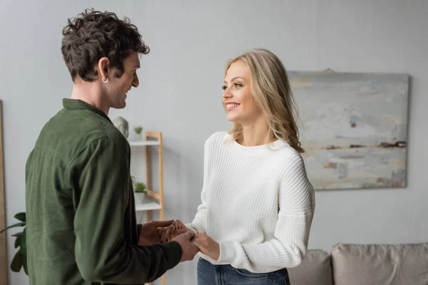 Happy Blonde Woman White Sweater Holding Hands Curly Man Shirt —  Fotos de Stock
