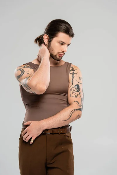 stock image Young tattooed man touching neck isolated on grey 