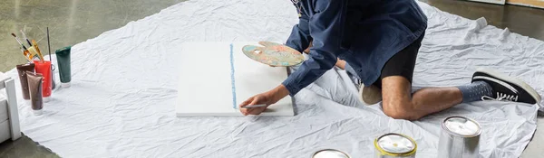 stock image Cropped view of african american artist painting on canvas in workshop, banner 