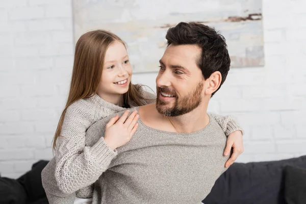 Cheerful Girl Embracing Bearded Father Smiling Home —  Fotos de Stock