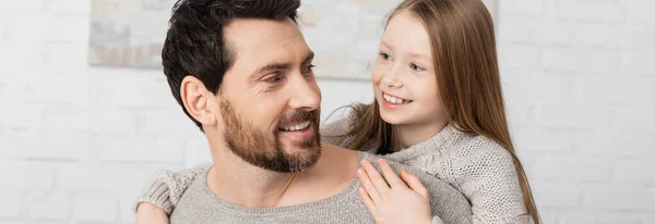 stock image happy preteen girl embracing smiling bearded dad at home, banner