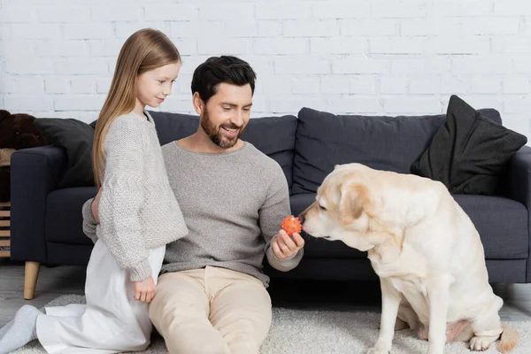 Cheerful Bearded Man Hugging Daughter While Holding Toy Labrador Dog —  Fotos de Stock