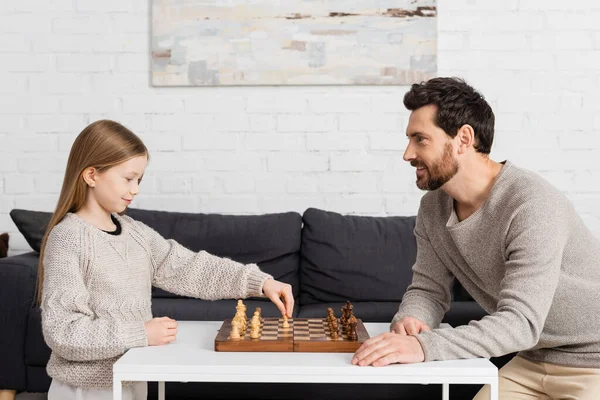 Side View Clever Girl Playing Chess Cheerful Father Living Room —  Fotos de Stock