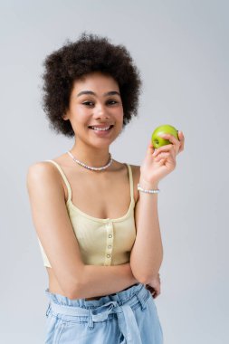 Üstte gri üzerine izole edilmiş elma tutan Afro-Amerikan modeli. 