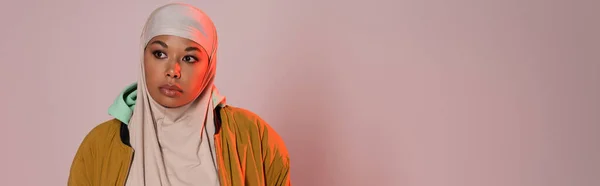 Pensive Monirotuinen Nainen Hijabissa Keltainen Tyylikäs Takki Etsii Pois Vaaleanpunainen — kuvapankkivalokuva