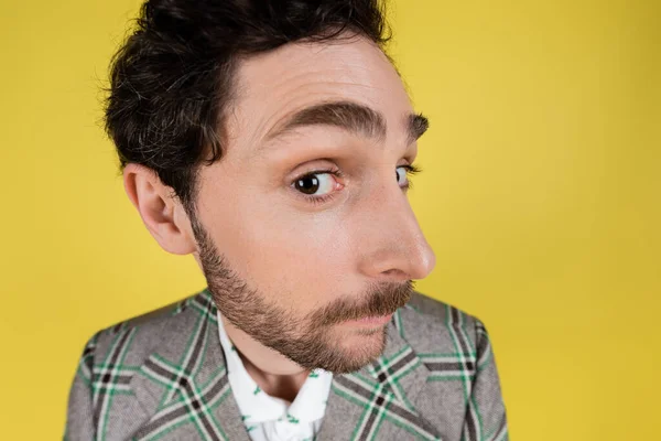 stock image Wide angle view of bearded man in jacket looking at camera isolated on yellow  