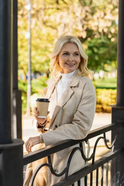 Carefree Blonde Woman Holding Takeaway Coffee While Standing Bridge Park — Stock Photo, Image
