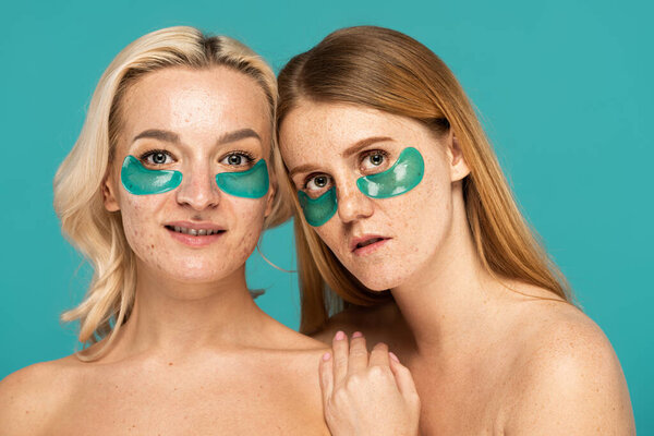 young women with different skin conditions and eye patches posing isolated on turquoise 