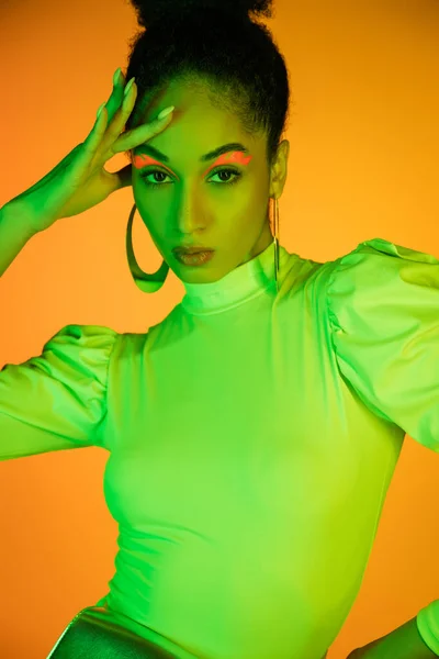 Portrait Fashionable African American Model Neon Visage Touching Face Orange — Stock Photo, Image
