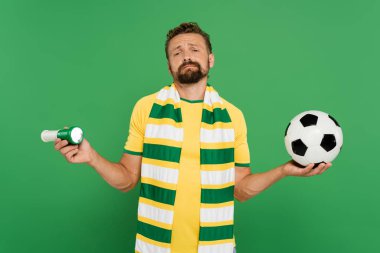 bearded soccer fan holding sports horn and football isolated on green  clipart