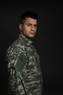 depressed soldier in uniform suffering from ptsd isolated on black  clipart