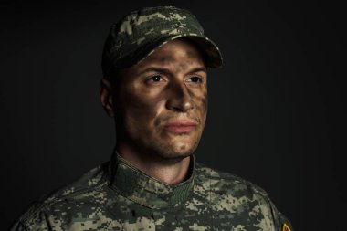 soldier with dirt on face standing in uniform and cap suffering from ptsd isolated on grey  clipart