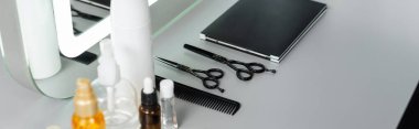 hairstyling products, hairdressing scissors, bottles, hair oil, comb, hair palette book near mirror in beauty salon, hair essentials, beauty industry, hair fashion, hair industry, banner clipart