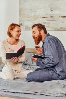 writing experience, notebook romance, married couple taking notes, day off without kids, redhead husband and happy wife, enjoying time, day off, weekends together, tattooed, parents alone at home  clipart
