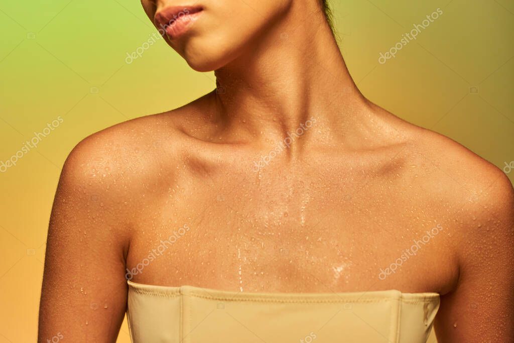 Hydration, cropped view of young woman with bare shoulders and wet body posing on gradient background, skincare campaign, beauty model, glowing skin, green background, natural beauty
