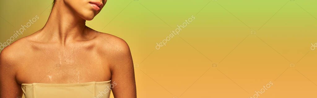 Hydration, cropped view of young woman with bare shoulders and wet body posing on gradient background, skincare campaign, beauty model, glowing skin, green background, natural beauty, banner