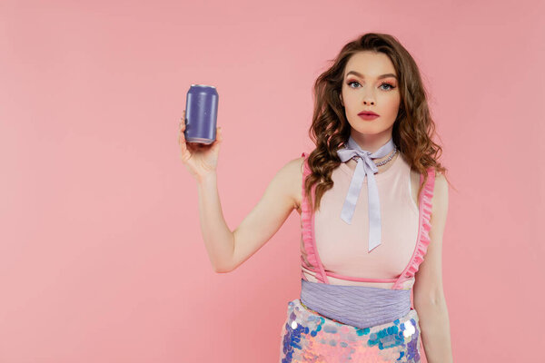 doll concept, attractive young woman with wavy hair holding soda can with carbonated drink, advertisement, standing on pink background, fashion model in stylish outfit, femininity, doll pose 