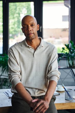 Cesur, koyu tenli, miastenya gravis hastalığı olan, bastonlu, ptosis göz sendromlu Afro-Amerikan ofis çalışanı, masasında kırtasiye malzemesi olan, profesyonel vesikalıkları olan bir adam. 