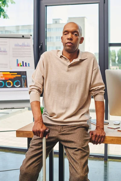 inclusion, myasthenia gravis syndrome, bold african american businessman standing with walking cane near computer monitor on working desk, dark skinned office worker in casual attire