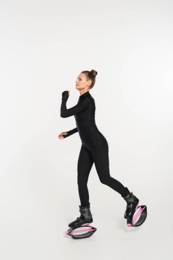 energy and strength, woman in kangoo jumping shoes exercising on white background, jumping boots  clipart