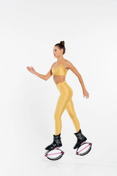 stock image woman in fitness clothing wearing kangoo jumping shoes, toned body, motivation, jumping boots 