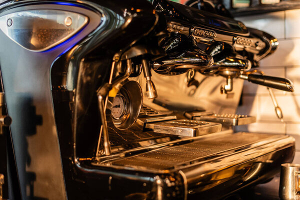 close up view of coffee machine with sunlight on worktop in coffee shop