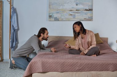 african american woman with pregnancy test, interracial couple discussing possibility of abortion clipart