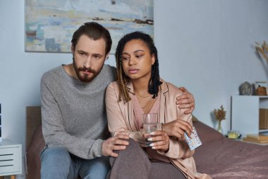 worried interracial couple looking at ultrasound photo, black woman and man, pregnancy, decision clipart
