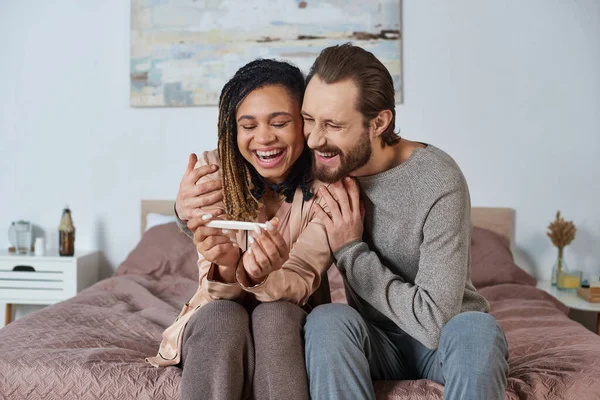 Interracial Couple Holding Cute Baby Clothes Tiny Shoes Future Parents — Stock Photo, Image