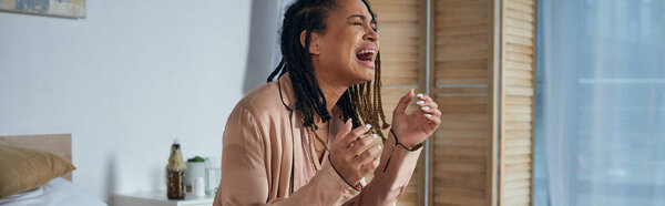 grief, depressed african american woman crying and screaming at home, miscarriage concept, banner